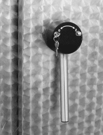  Circular black knob with a rod facing downward. A key hangs from a lock in the knob.Circular black knob with a rod facing downward. A key hangs from a lock in the knob.
